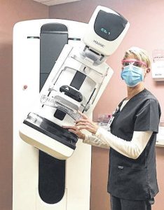 Image of Radiology Technician Carla Hoyng with the new 3D mammography device at Morrow County Hospital.